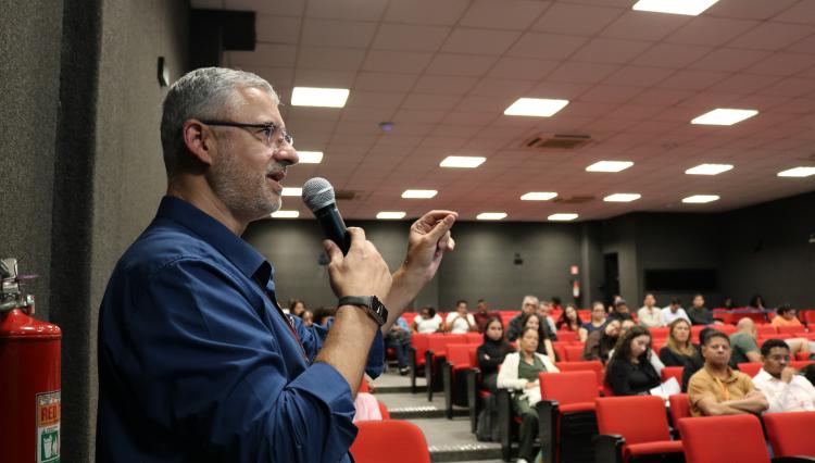 Alunos reunidos no auditório para palestra sobre IA e Negócios.